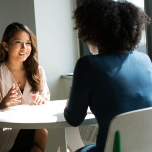 two women talking at work